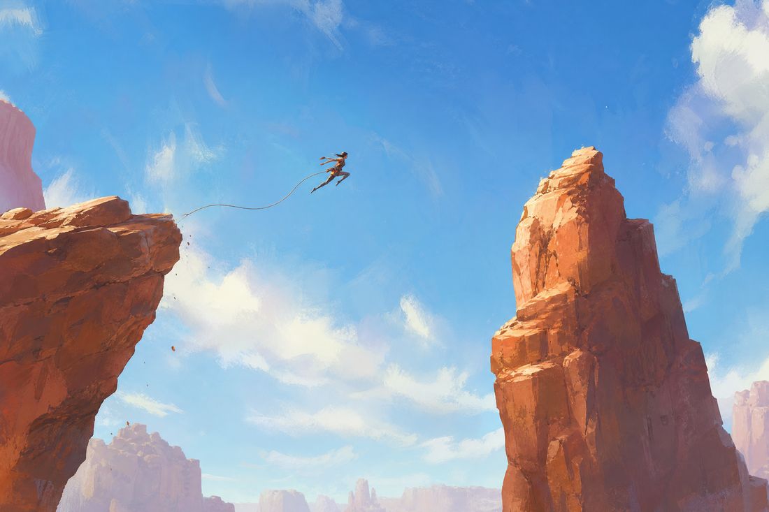 A lean figure at the apex of a long jump between two sandstone spires under a bright blue sky